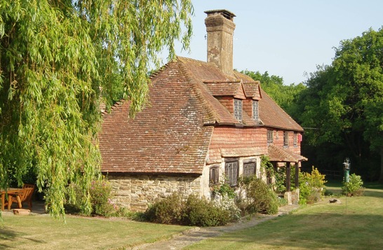 Croft’s Folly, a tile-hung cottage behind a weeping willow